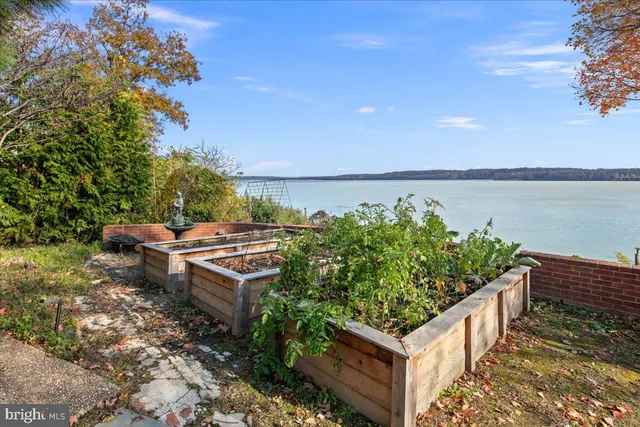 a view of a big house with a big yard and large trees
