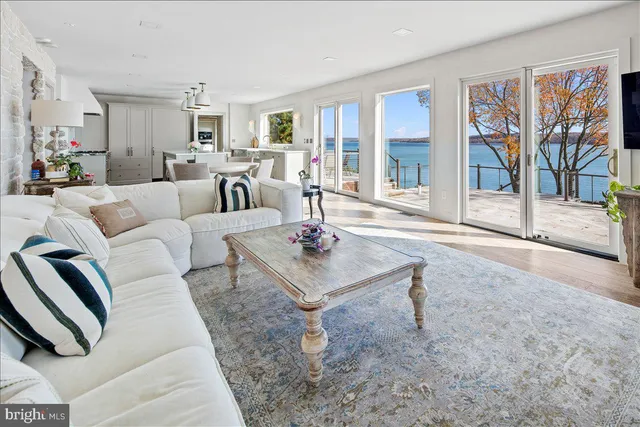 a view of a dining room with furniture a rug and wooden floor
