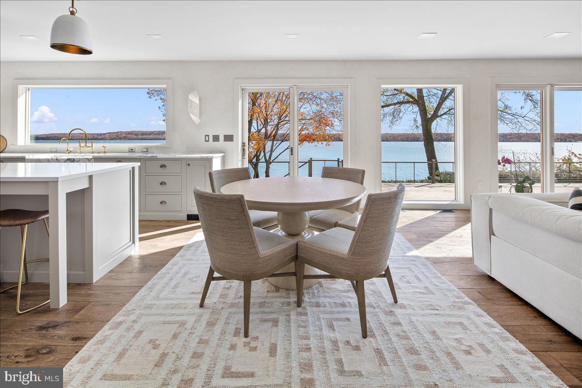 3903 Belle Rive Terrace Alexandria, VA 22309 - Photo 9 of 69 a view of a dining room with furniture a rug and wooden floor