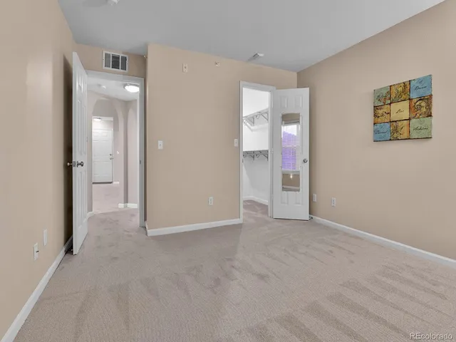 a view of a hallway with wooden shelves