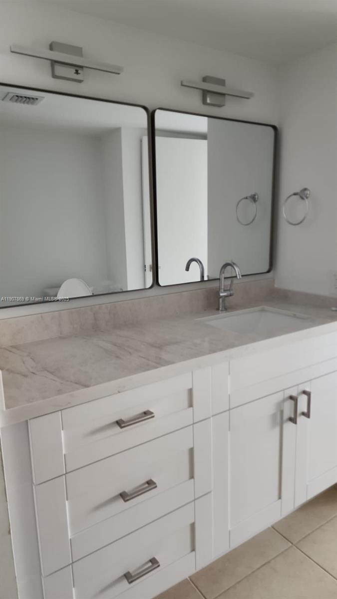 201 Crandon Boulevard, Unit 936 Key Biscayne, FL 33149 - Photo 12 of 18 a bathroom with a sink and vanity