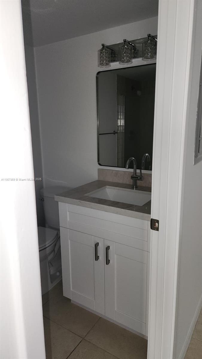 201 Crandon Boulevard, Unit 936 Key Biscayne, FL 33149 - Photo 8 of 18 a bathroom with a sink and a mirror