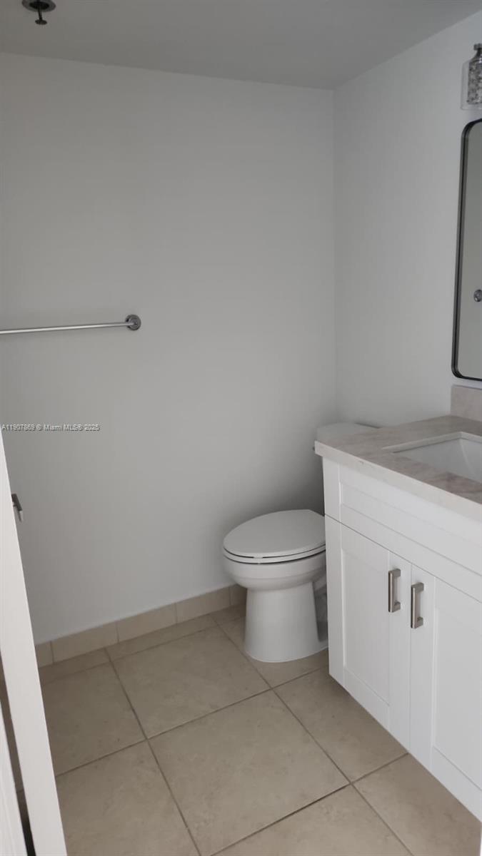 201 Crandon Boulevard, Unit 936 Key Biscayne, FL 33149 - Photo 9 of 18 a white toilet sitting next to a white sink