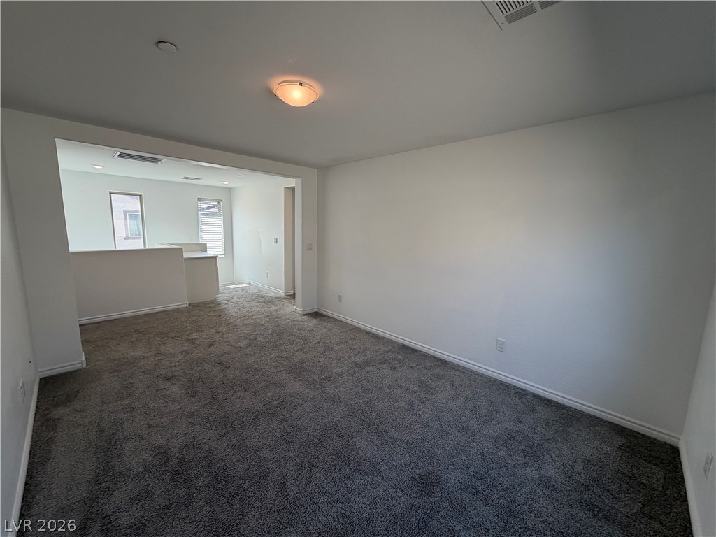 3228 Azalea Ridge Court Henderson, NV 89052 - Photo 18 of 28 An inviting secondary living area features soft carpeting and ample space for relaxation.