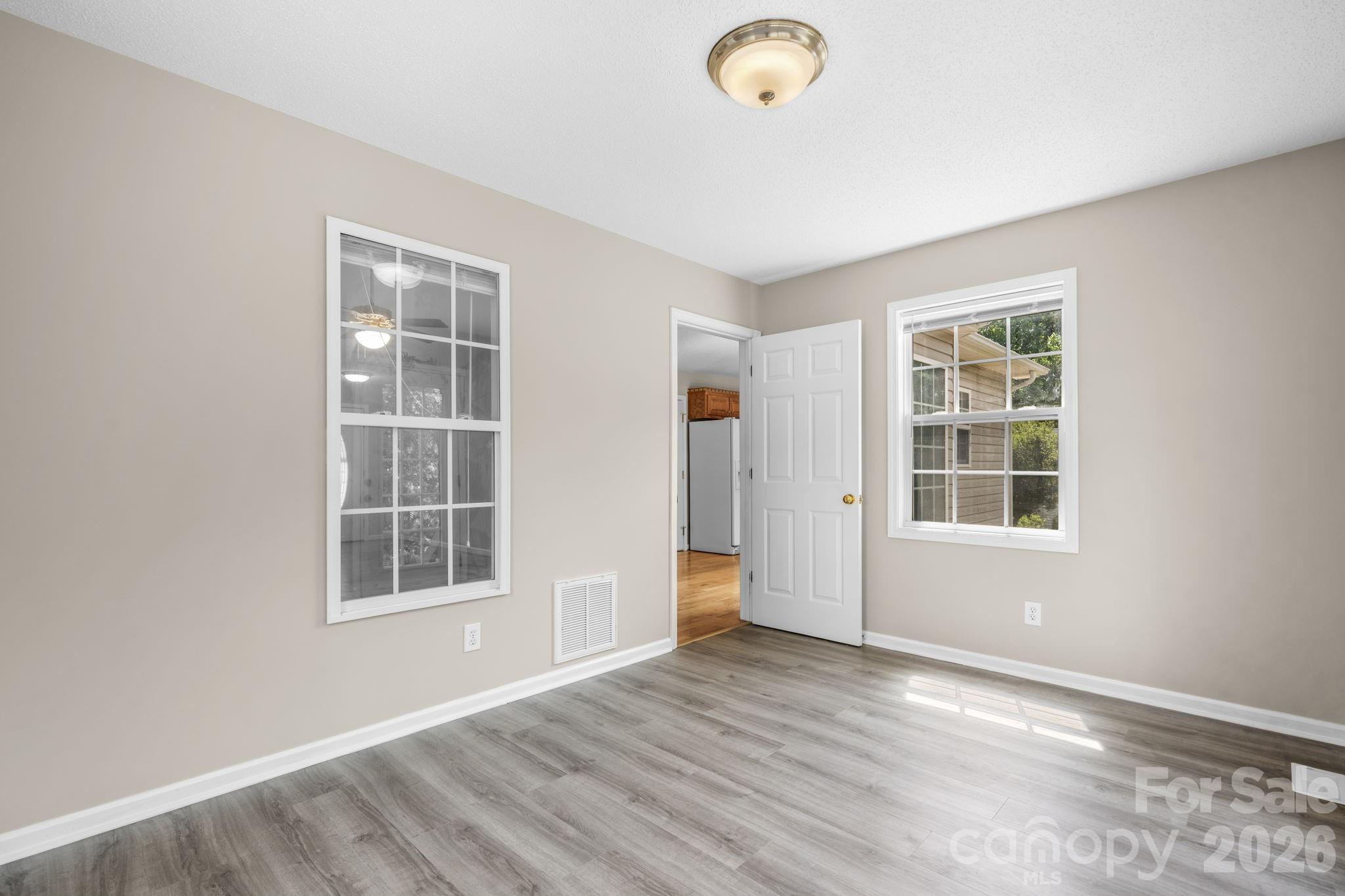 4967 Addison Lane Hickory, NC 28601 - Photo 13 of 43 an empty room with wooden floor and windows