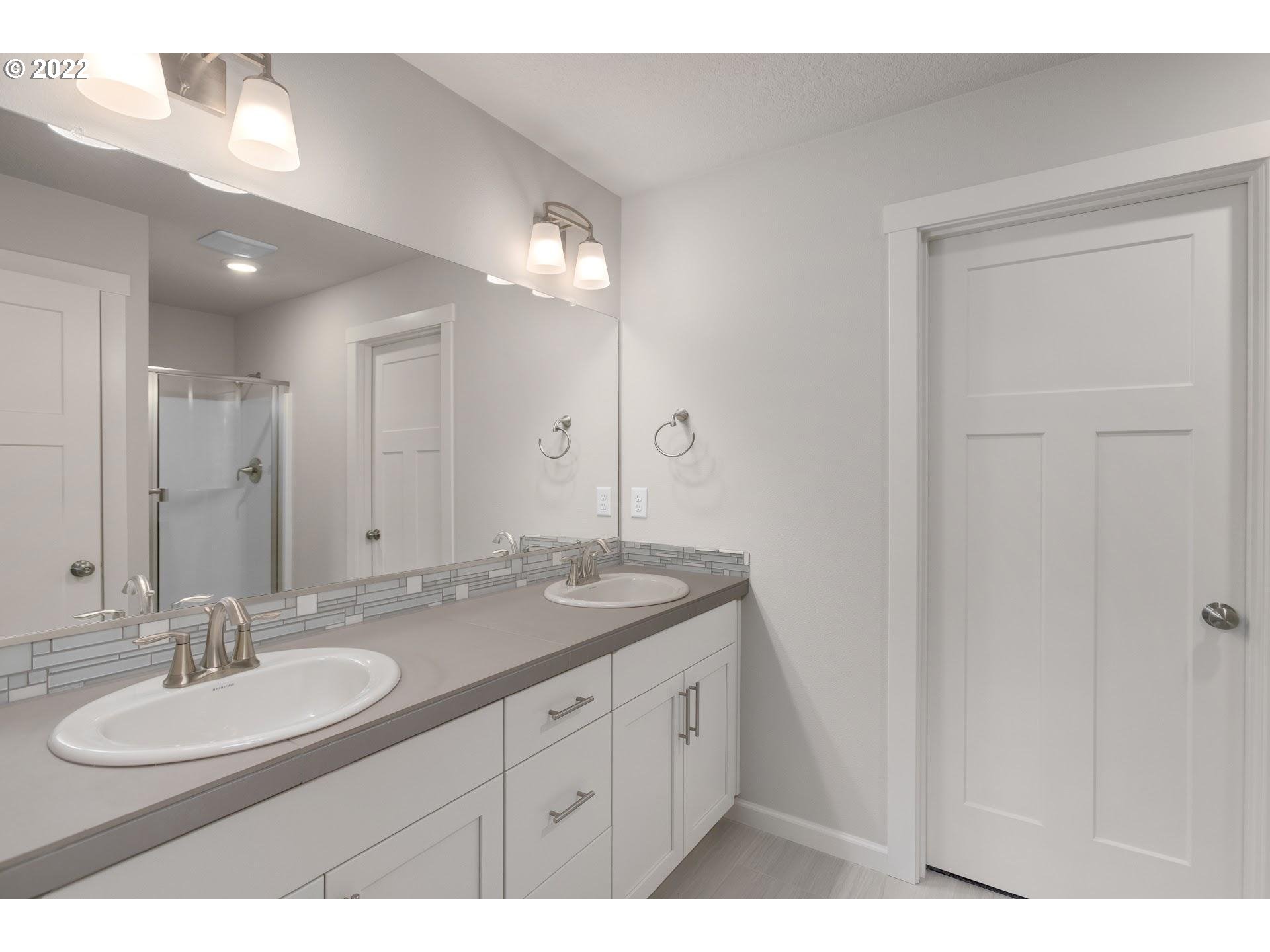 2415 South Trail View Ridgefield, WA 98642 - Photo 26 of 31 a bathroom with a granite countertop sink a mirror and a
