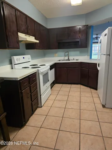 a kitchen with a cabinets and a stove top oven