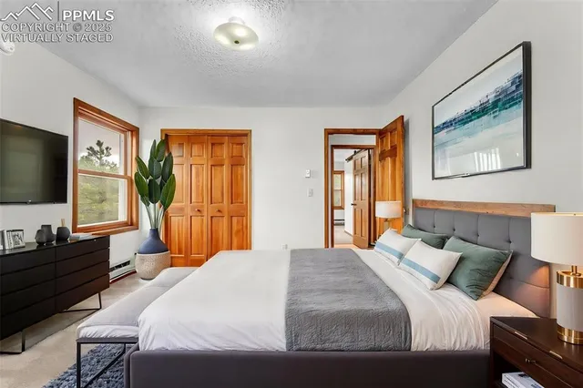 a bedroom with a bed and a flat screen tv