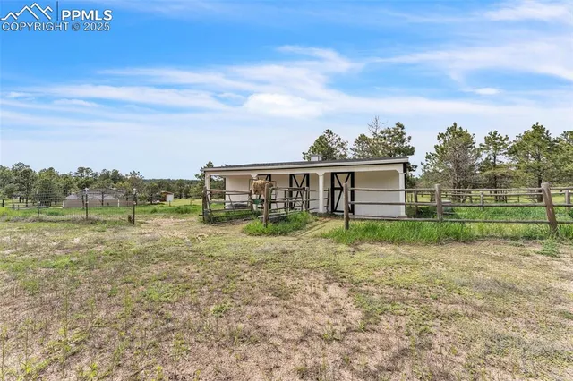a view of a house with a yard and sitting area