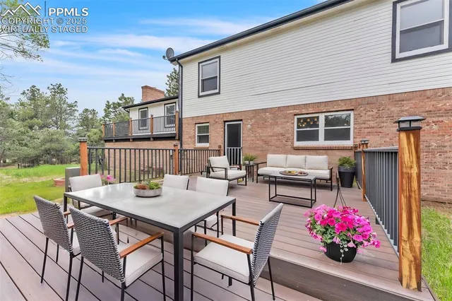 a view of backyard with outdoor seating and yard