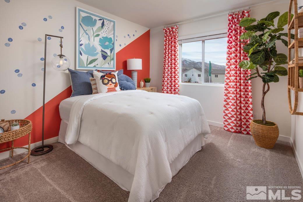 7789 Wandering Way, Unit LOT #243 Reno, NV 89506 - Photo 12 of 15 a bedroom with a bed and a potted plant