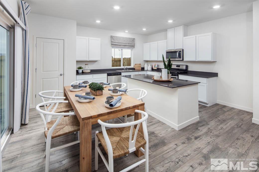 7789 Wandering Way, Unit LOT #243 Reno, NV 89506 - Photo 5 of 15 a view of kitchen with cabinets appliances and wooden floor