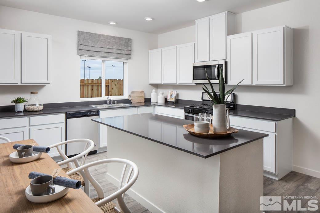 7789 Wandering Way, Unit LOT #243 Reno, NV 89506 - Photo 7 of 15 a kitchen with cabinets a sink and a stove