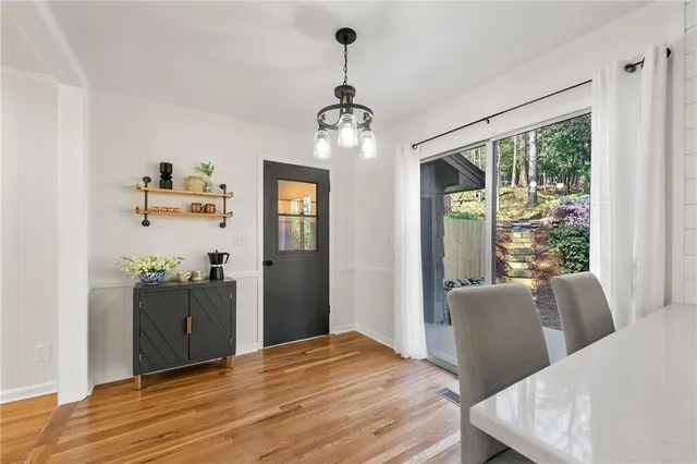 a view of a dining room with furniture window and wooden floor