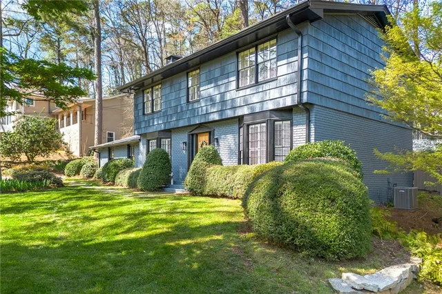 a view of a house with a yard and plants