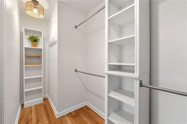 a view of walk in closet with empty racks