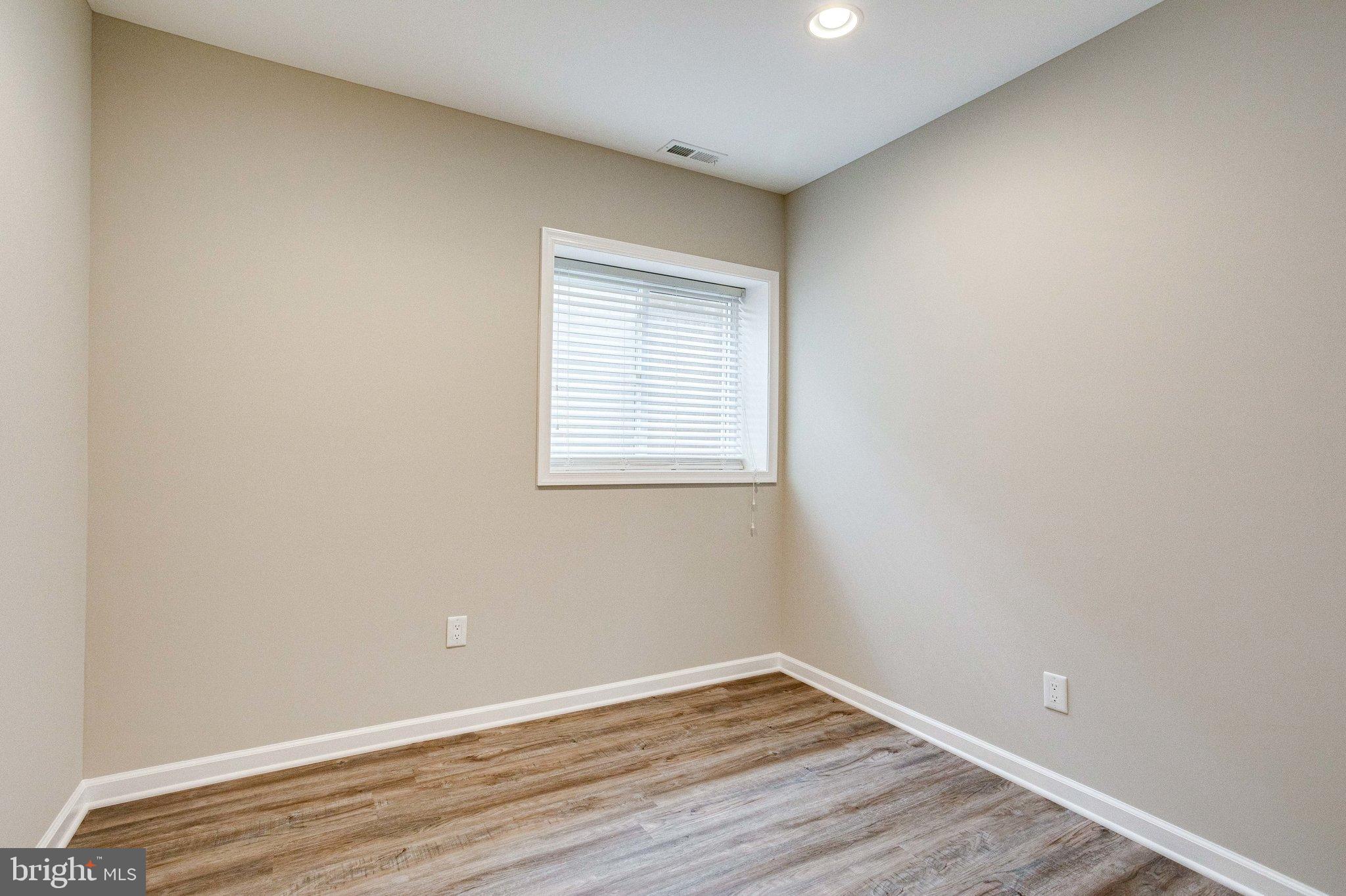 2648 Bowen Road Southeast Washington, DC 20020 - Photo 23 of 36 a view of an empty room with wooden floor and a window