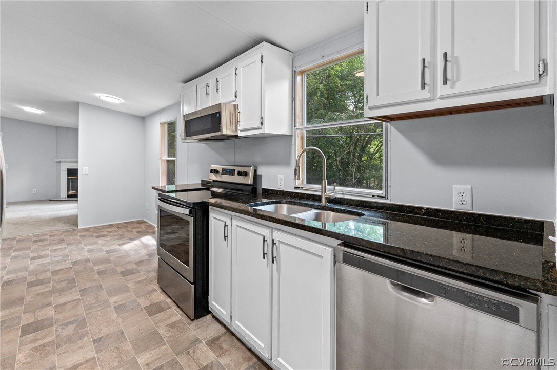1172 Hendricks Road Pamplin, VA 23958 - Photo 11 of 36 a kitchen with stainless steel appliances granite countertop a sink stove and cabinets