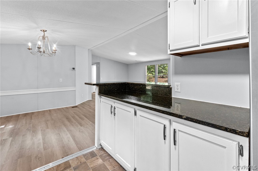 1172 Hendricks Road Pamplin, VA 23958 - Photo 12 of 36 a kitchen with granite countertop white cabinets and a sink