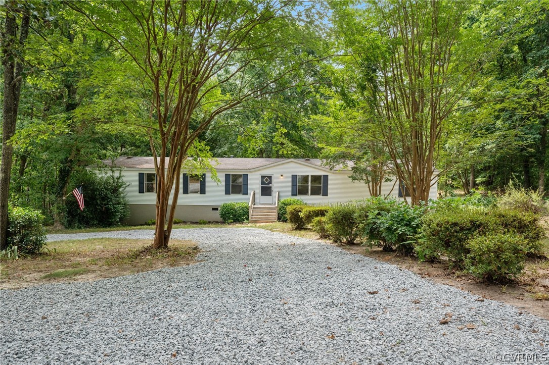 1172 Hendricks Road Pamplin, VA 23958 - Photo 2 of 36 a front view of a house with a garden and trees