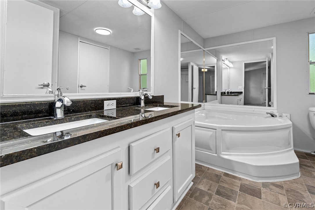 1172 Hendricks Road Pamplin, VA 23958 - Photo 21 of 36 a bathroom with a double vanity sink and mirror