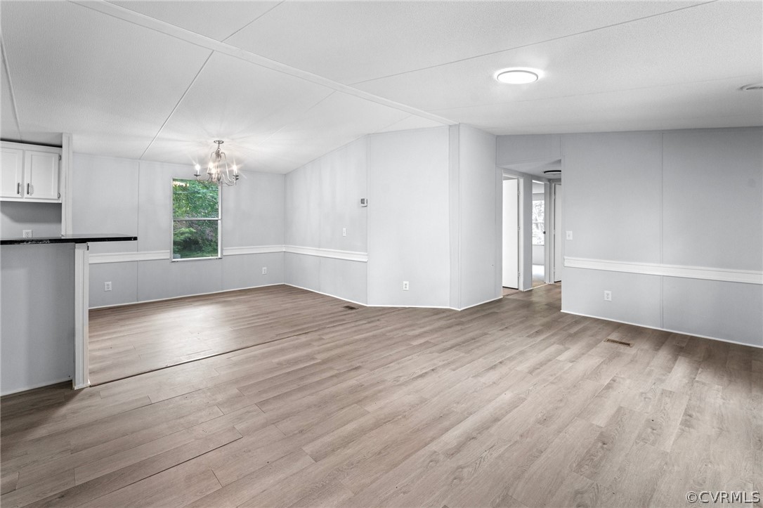 1172 Hendricks Road Pamplin, VA 23958 - Photo 4 of 36 an empty room with wooden floor and windows
