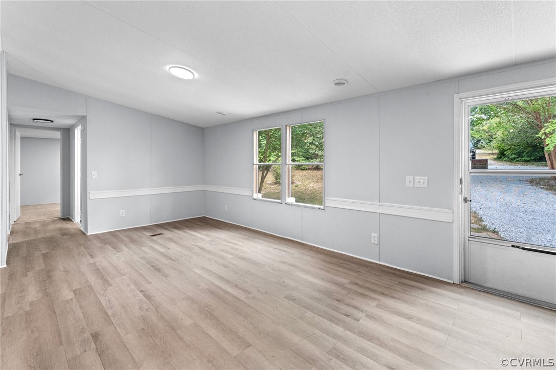 1172 Hendricks Road Pamplin, VA 23958 - Photo 5 of 36 an empty room with wooden floor and windows