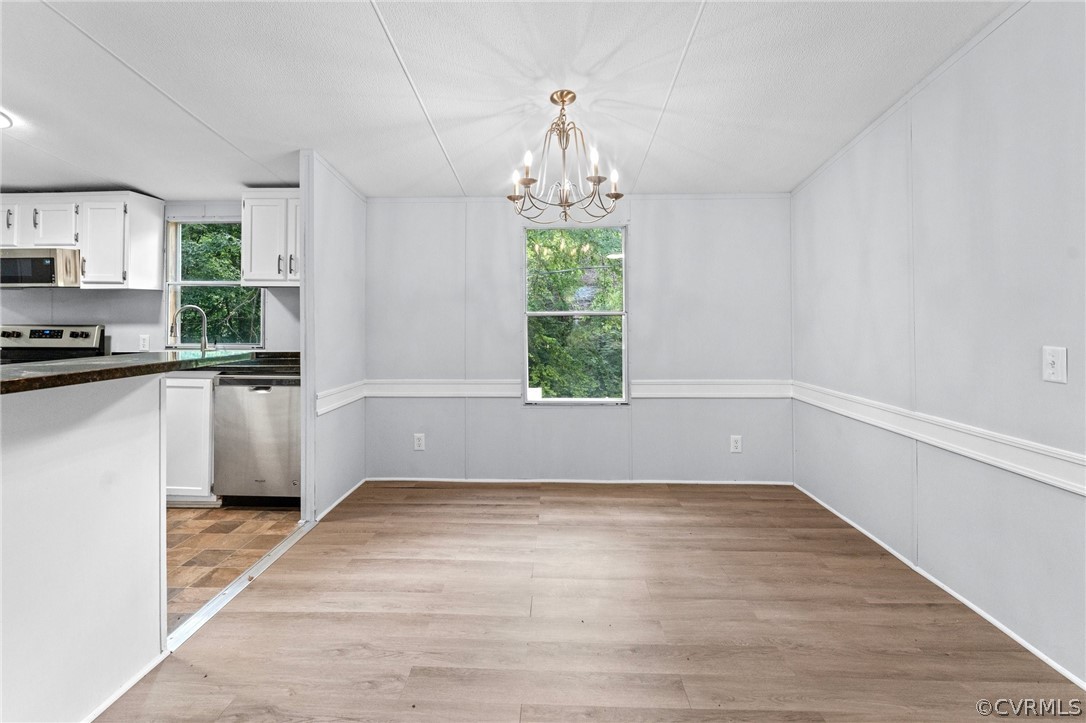 1172 Hendricks Road Pamplin, VA 23958 - Photo 9 of 36 wooden floor in an empty room with a window