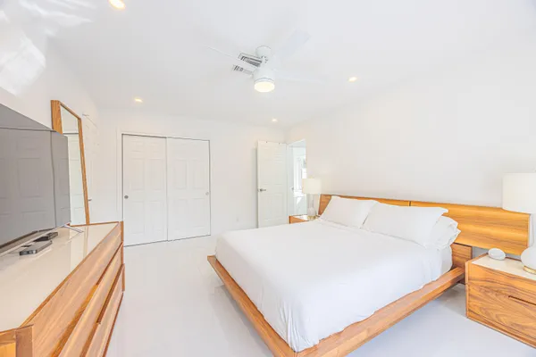 a bedroom with a bed and a chandelier
