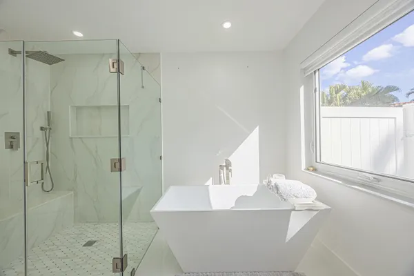 a bathroom with a bathtub and shower