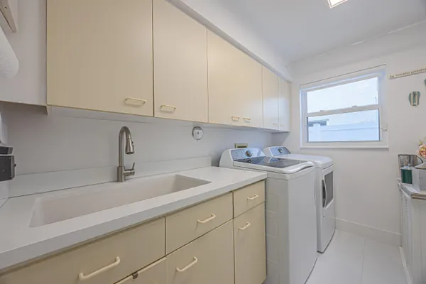 a view of a kitchen sink cabinets and a window