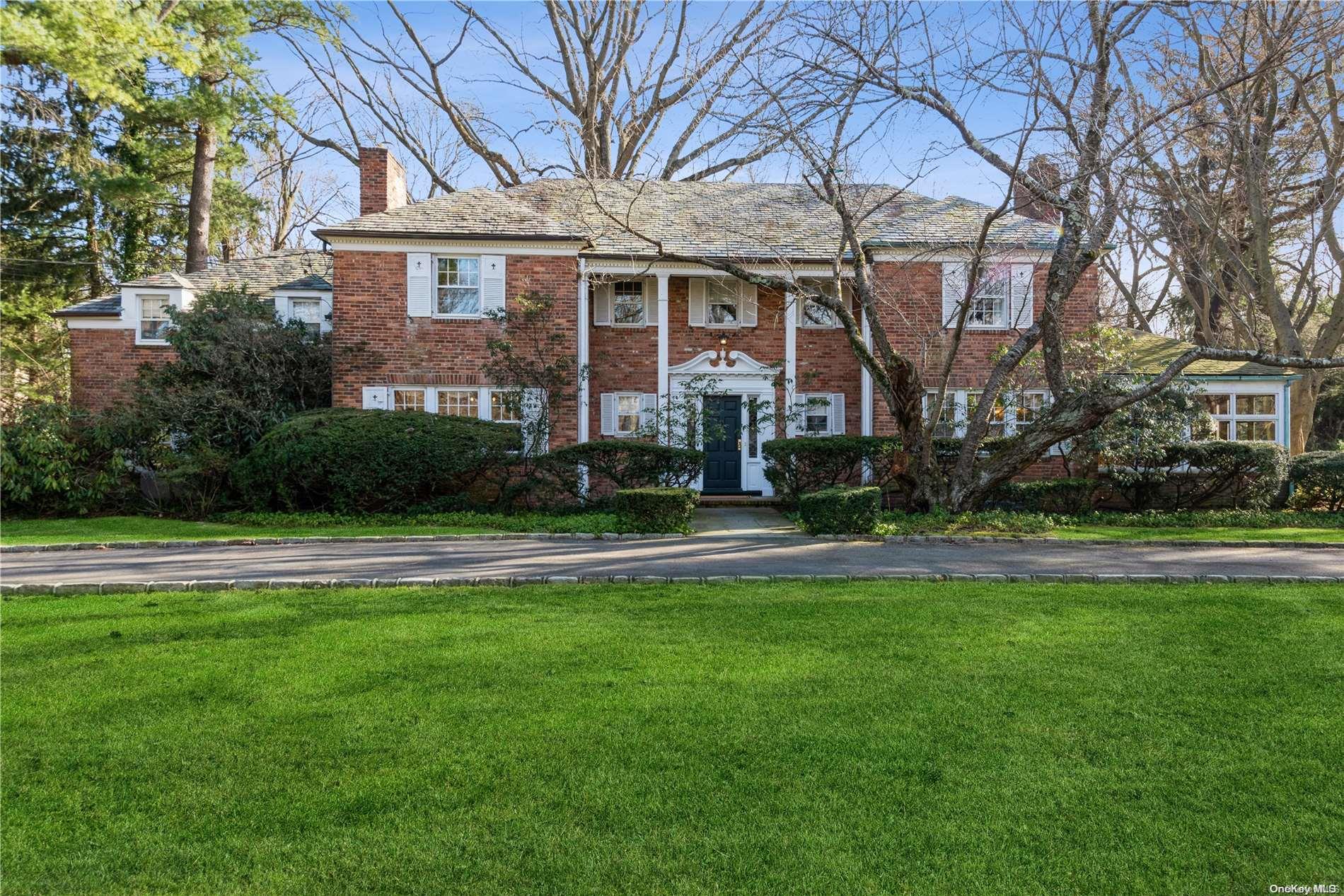 70 Barkers Point Road Sands Point, NY 11050 - Photo 1 of 1 a front view of house with yard and green space
