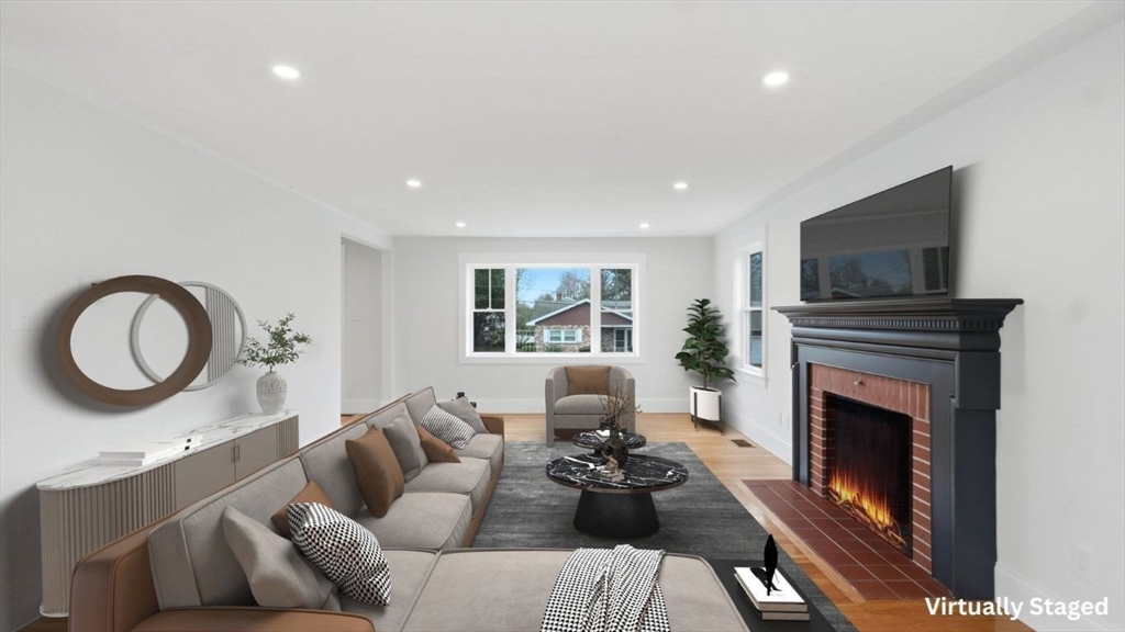105 Stafford Road Lowell, MA 01852 - Photo 4 of 42 a living room with furniture a fireplace and a flat screen tv