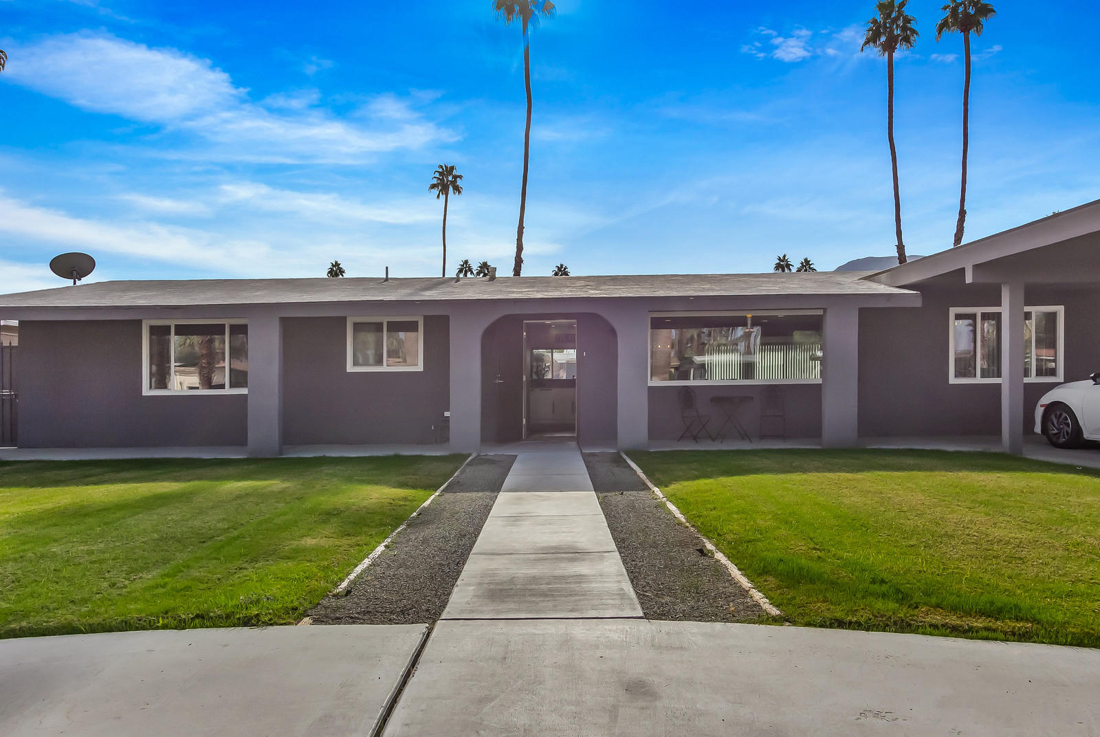 70061 Chappel Road Rancho Mirage, CA 92270 - Photo 2 of 26 a front view of a house with garden