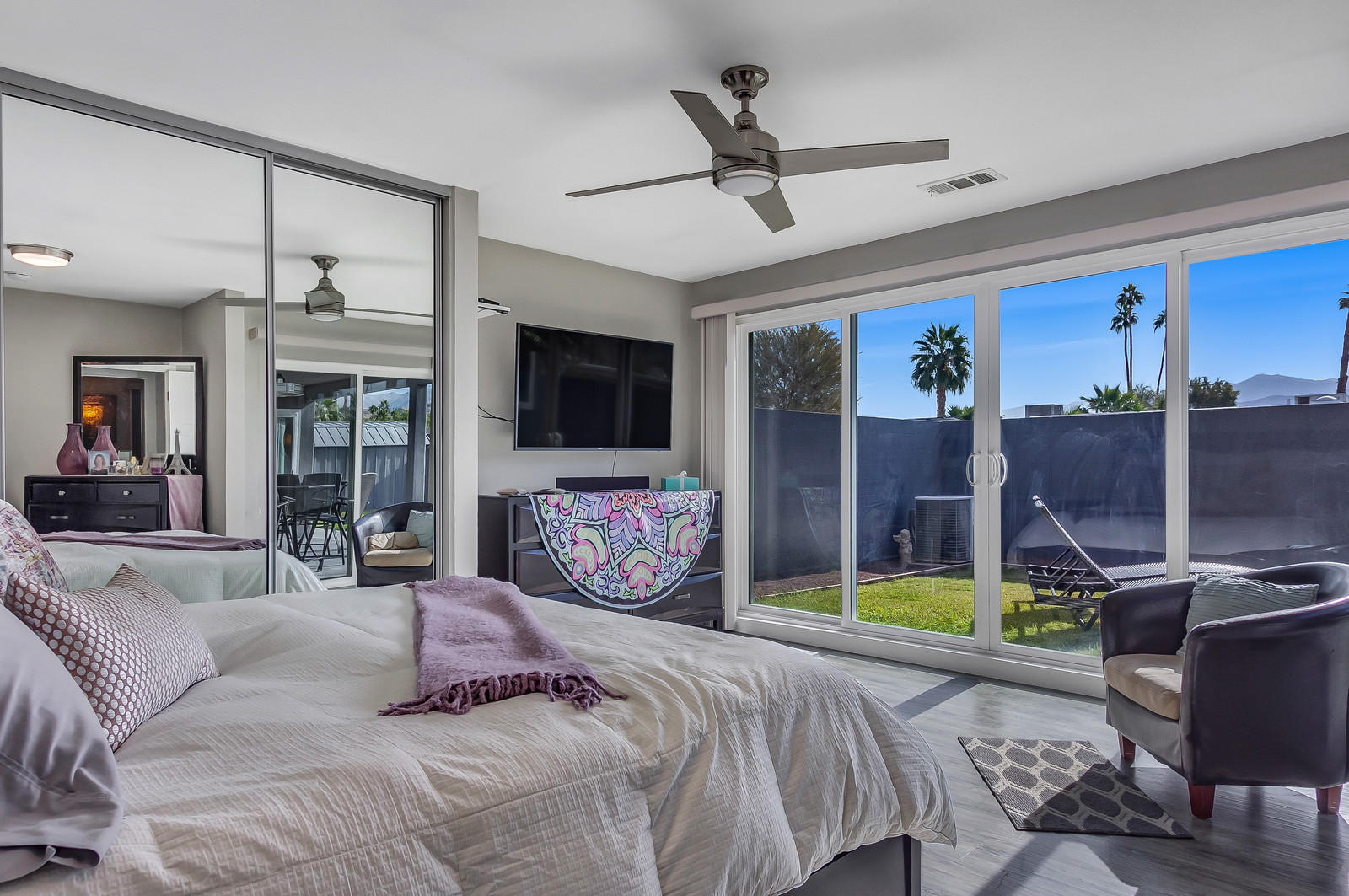 70061 Chappel Road Rancho Mirage, CA 92270 - Photo 14 of 26 a bedroom with a bed a chandelier and flat screen tv