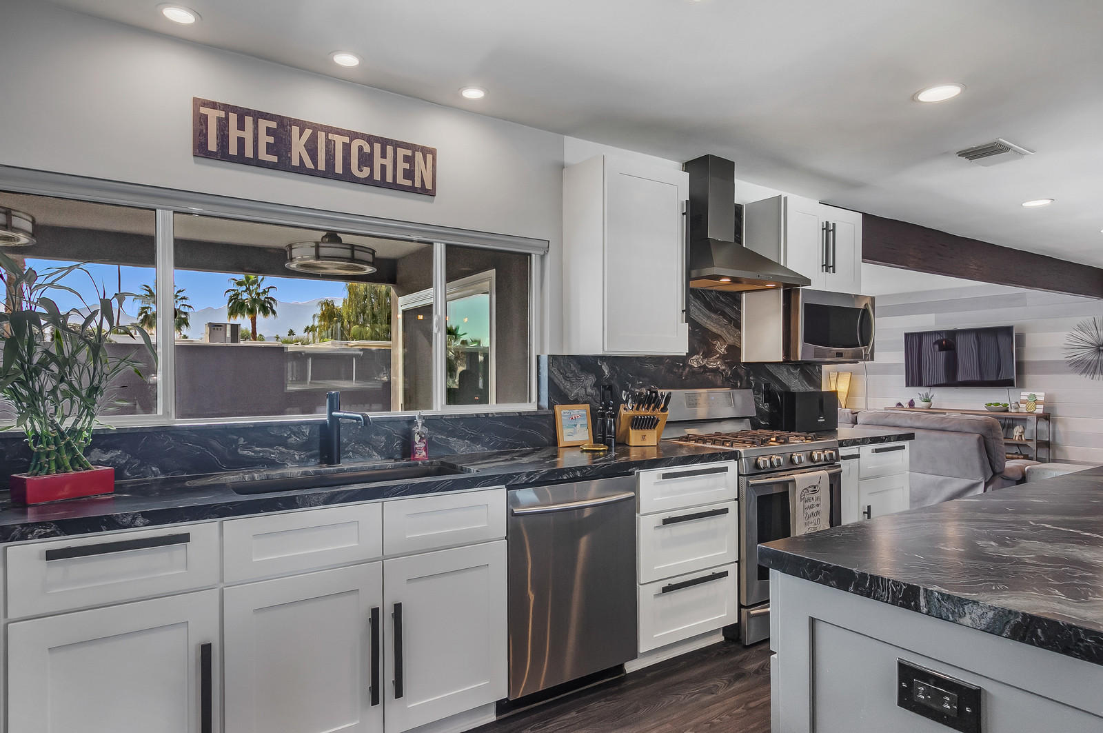 70061 Chappel Road Rancho Mirage, CA 92270 - Photo 10 of 26 a kitchen with stainless steel appliances granite countertop a sink and cabinets