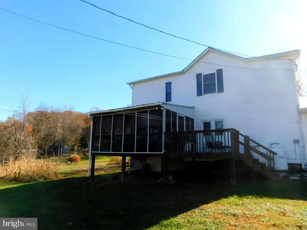 a view of house with backyard porch and garden