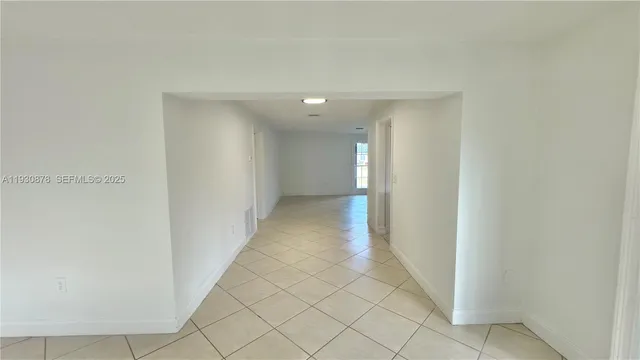 a view of a hallway with chandelier