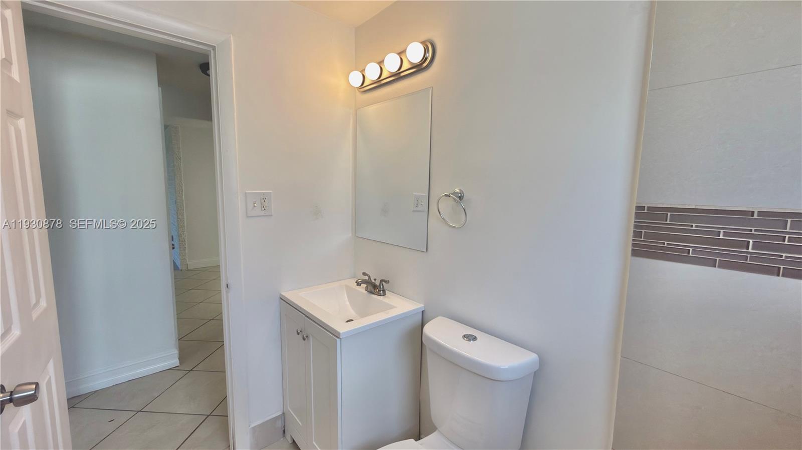 6504 Arbor Drive, Unit 6504 Miramar, FL 33023 - Photo 18 of 31 a white toilet sitting next to a bathroom sink