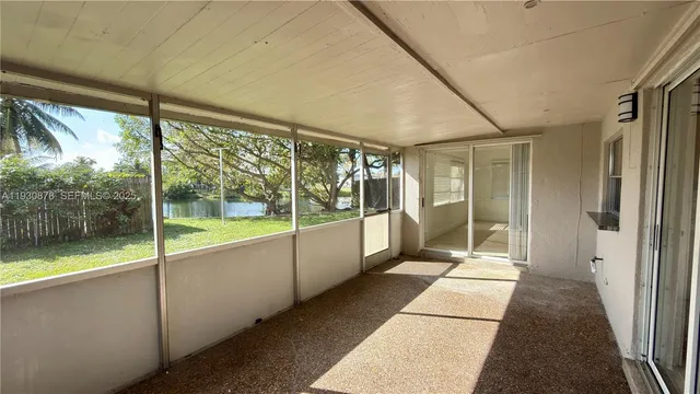 a view of a large room with wooden floor and windows