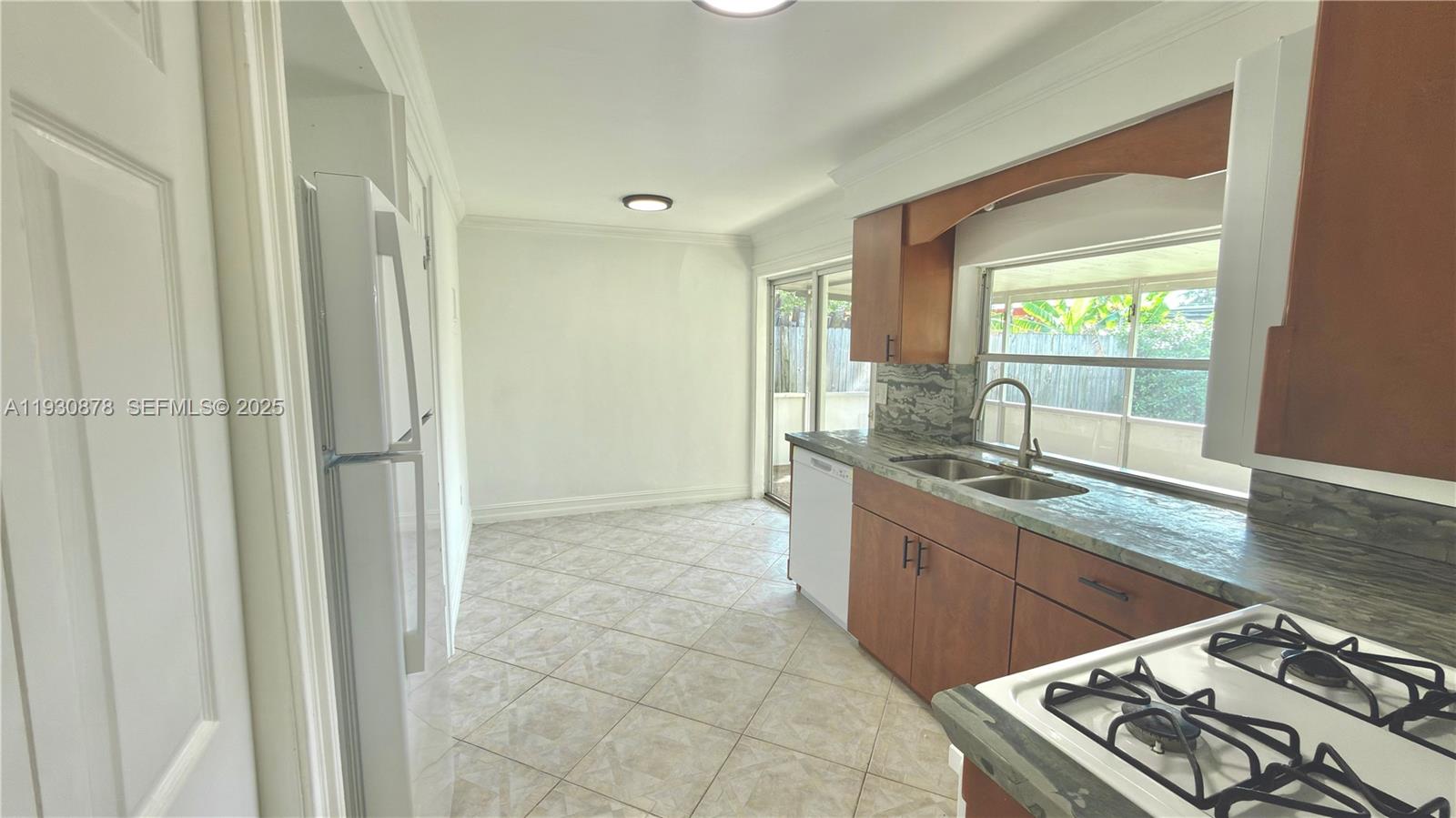 6504 Arbor Drive, Unit 6504 Miramar, FL 33023 - Photo 4 of 31 a kitchen with a sink stove and cabinets