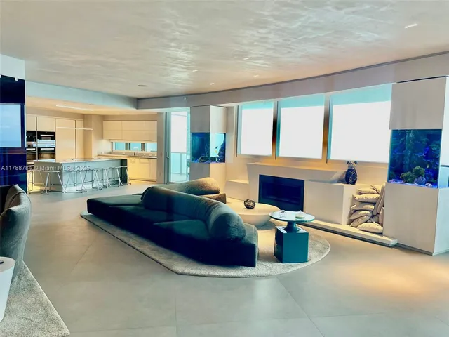 a kitchen with stainless steel appliances a table chairs and a refrigerator