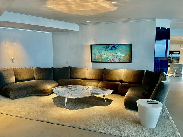 a living room with a table and a fireplace