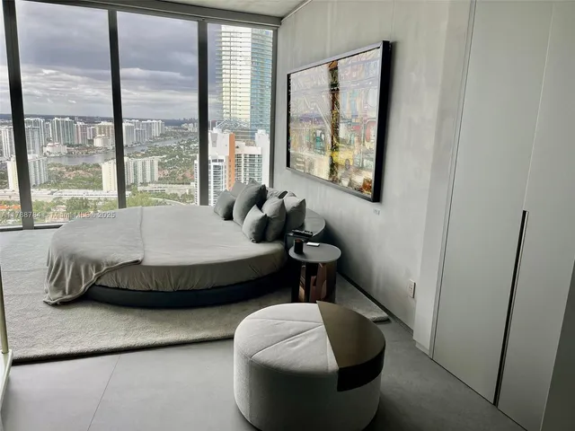 a living room with fireplace furniture and a large window