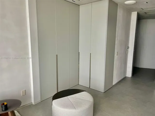 a hallway with wooden floor and windows