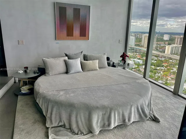 a bed sitting in a room next to a bathroom