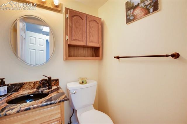 691 Gilcrest Road Colorado Springs, CO 80906 - Photo 22 of 28 Downstairs 1/2 bath with granite countertop