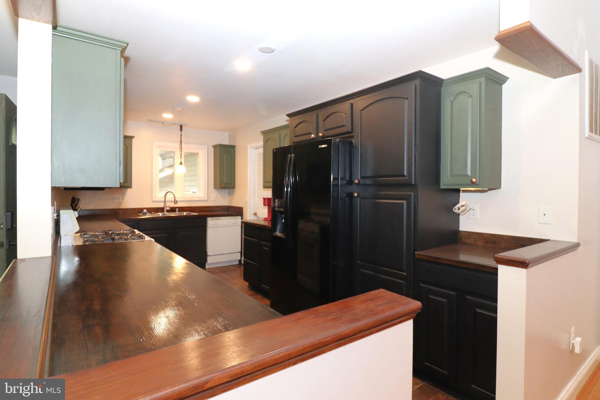 1111 Eastover Parkway Locust Grove, VA 22508 - Photo 14 of 62 a kitchen with stainless steel appliances kitchen island granite countertop a refrigerator a stove and a sink