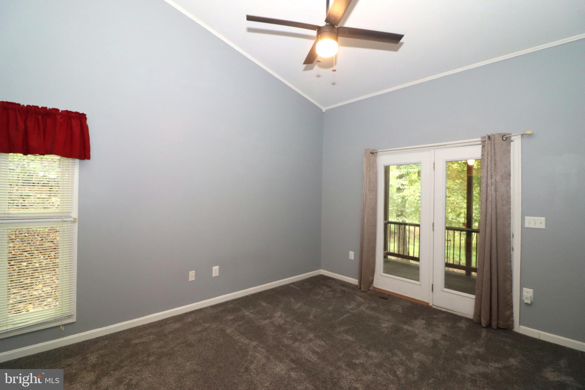 1111 Eastover Parkway Locust Grove, VA 22508 - Photo 17 of 62 an empty room with windows and fan