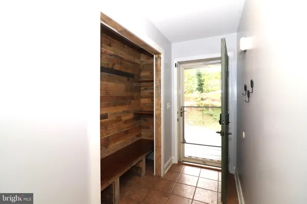 an empty room with windows and ceiling fan